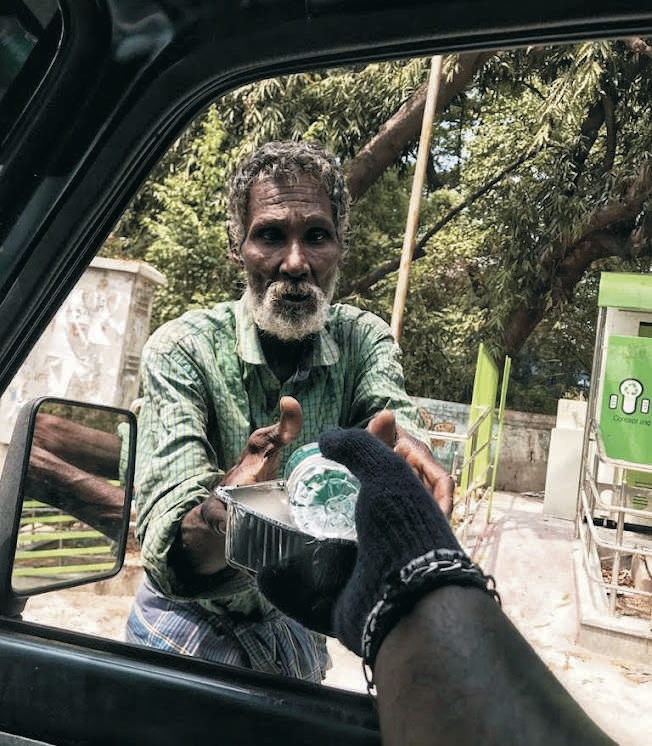 D. Arul Raj at the wheel of his autorickshaw between rescue rounds in Chennai